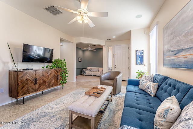 tiled living room with ceiling fan