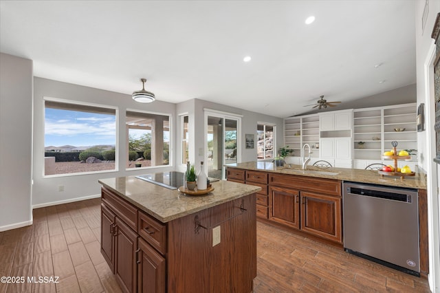 kitchen with black electric stovetop, dishwasher, vaulted ceiling, a kitchen island, and sink