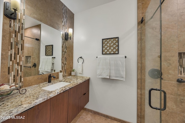 bathroom featuring an enclosed shower and vanity