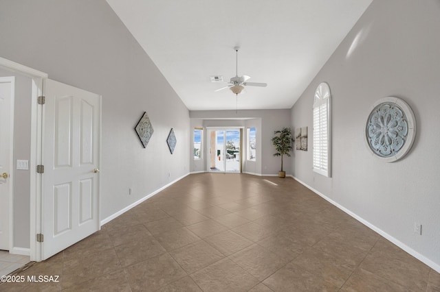 empty room featuring ceiling fan and vaulted ceiling