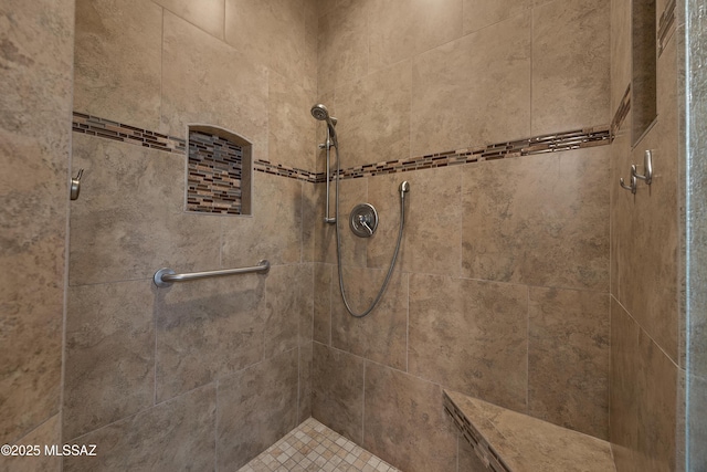 bathroom with tiled shower