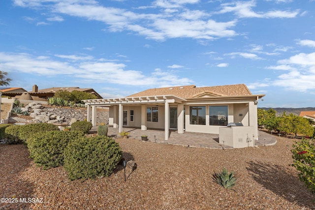 rear view of house with a pergola and a patio