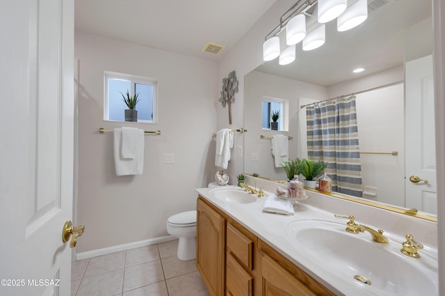 bathroom featuring toilet, vanity, tile patterned flooring, and curtained shower