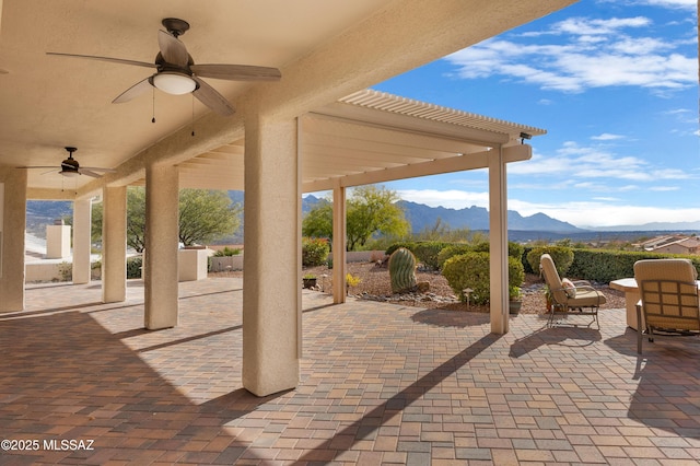 view of patio / terrace featuring a mountain view and ceiling fan