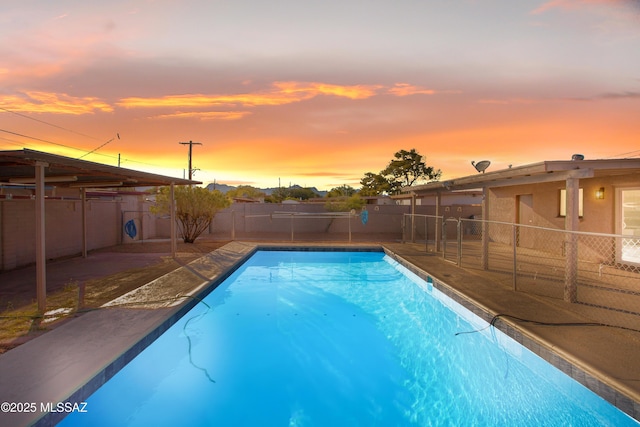 view of pool at dusk