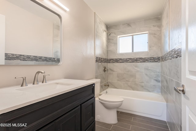 full bathroom featuring vanity, toilet, and tiled shower / bath