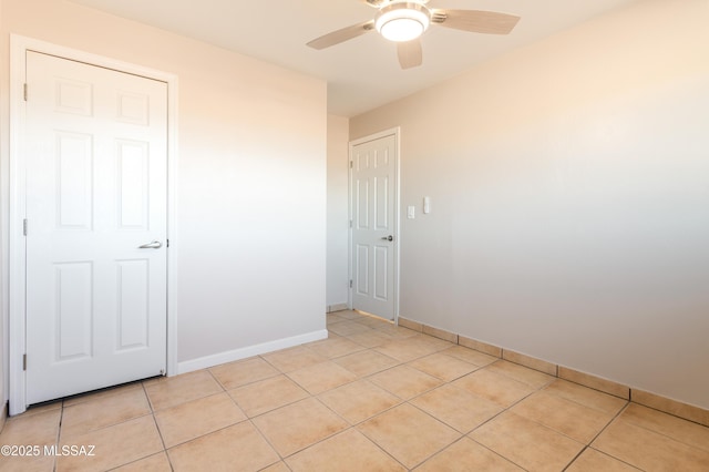 unfurnished room featuring ceiling fan and light tile patterned flooring