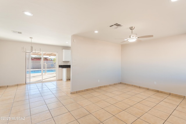 unfurnished room with ceiling fan and light tile patterned floors