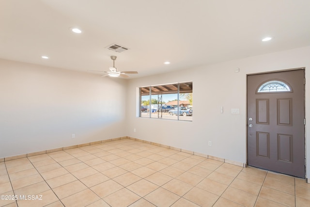 tiled entryway featuring ceiling fan