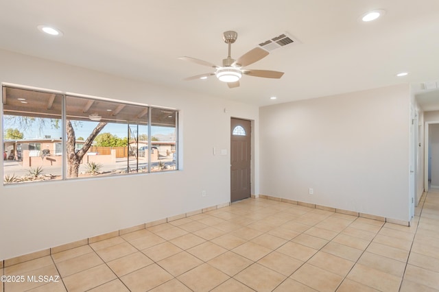 tiled empty room with ceiling fan