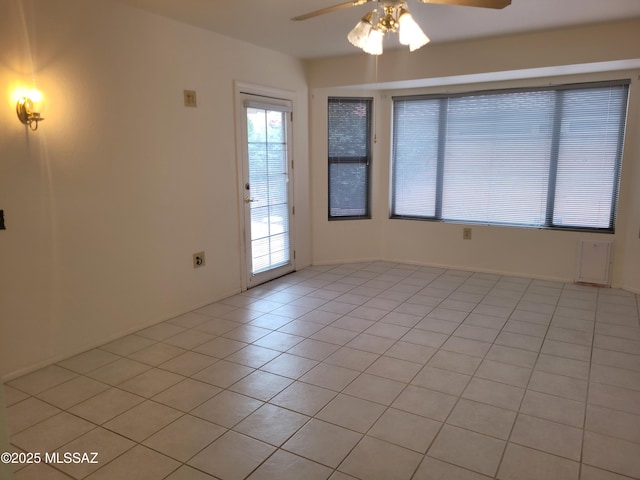 tiled empty room with ceiling fan