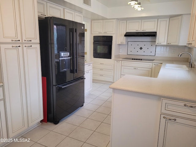 kitchen with backsplash, black appliances, sink, light tile patterned flooring, and kitchen peninsula