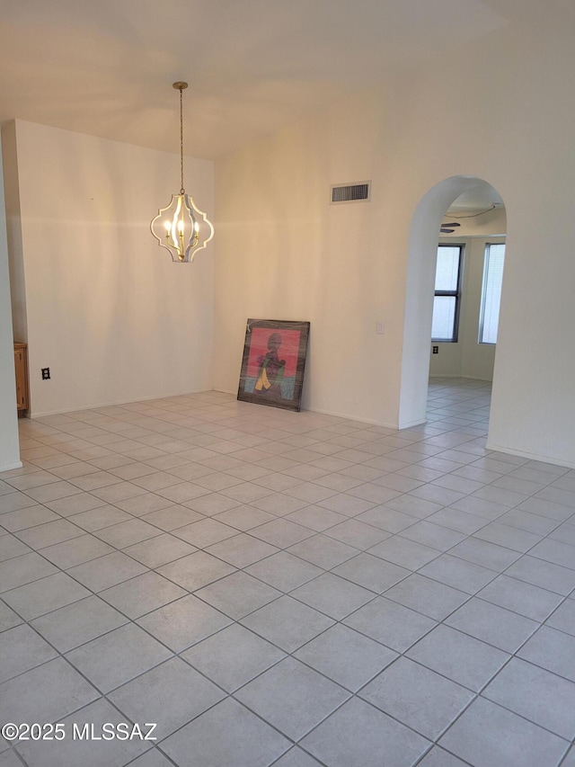 unfurnished room featuring light tile patterned floors and a notable chandelier