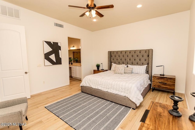 bedroom featuring lofted ceiling, hardwood / wood-style floors, connected bathroom, and ceiling fan