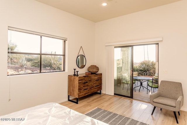 bedroom with light hardwood / wood-style floors and access to outside