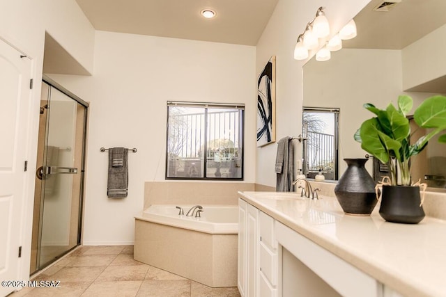 bathroom with plus walk in shower, tile patterned floors, a wealth of natural light, and vanity