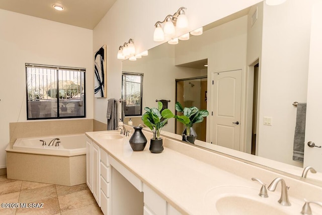 bathroom with vanity and independent shower and bath