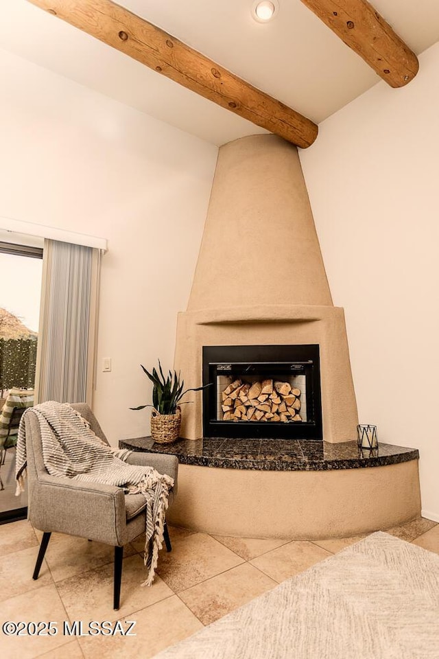 details featuring a large fireplace and beam ceiling