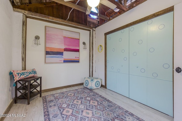 interior space with hardwood / wood-style flooring, vaulted ceiling, and ceiling fan