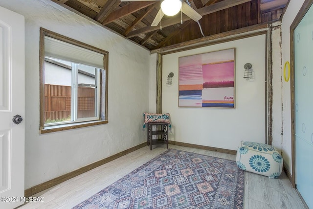 interior space featuring hardwood / wood-style floors, vaulted ceiling with beams, ceiling fan, and wood ceiling