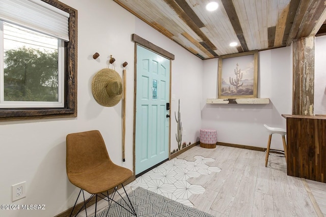 entryway featuring light hardwood / wood-style flooring and wood ceiling