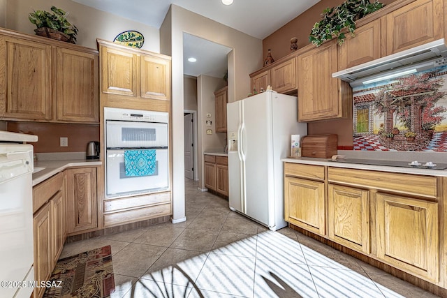 kitchen with range hood, white appliances, and light tile patterned floors