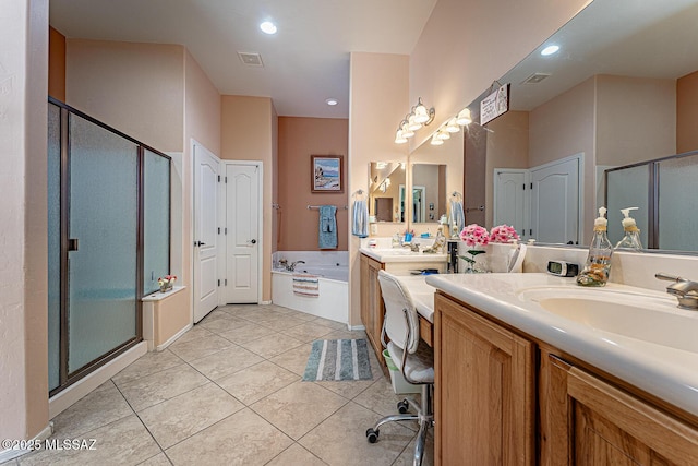 bathroom featuring plus walk in shower, vanity, and tile patterned floors