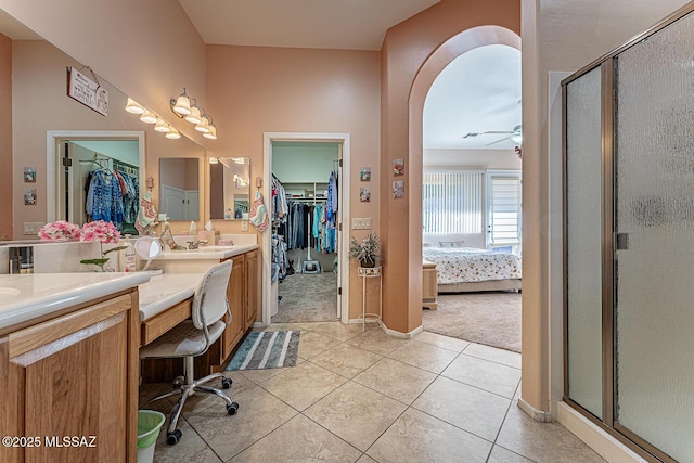 bathroom featuring vanity, tile patterned floors, and a shower with shower door