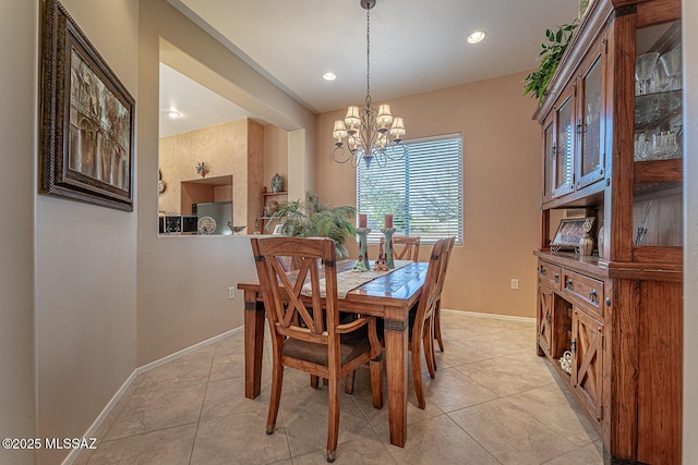 dining area featuring a chandelier and light tile patterned flooring