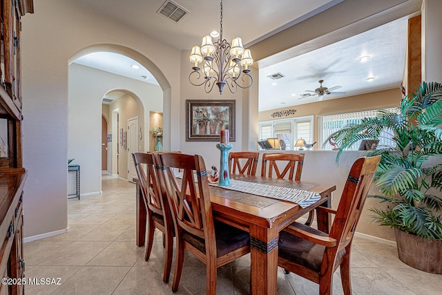 tiled dining area with ceiling fan with notable chandelier