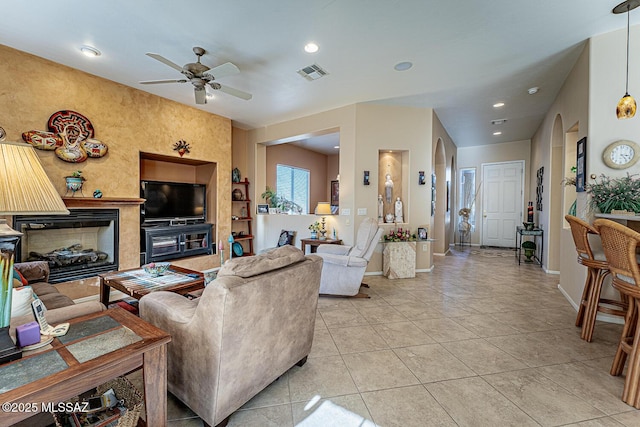 living room featuring ceiling fan and light tile patterned floors