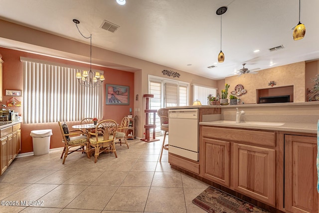 kitchen featuring dishwasher, ceiling fan with notable chandelier, sink, and hanging light fixtures