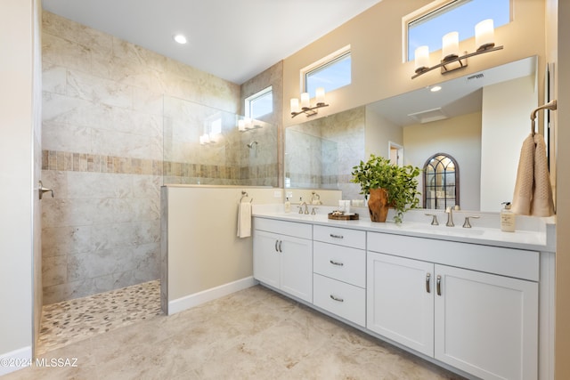 bathroom featuring vanity and tiled shower