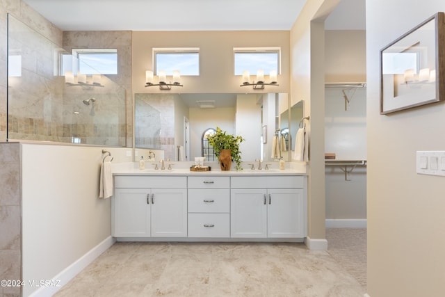 bathroom with vanity and a tile shower