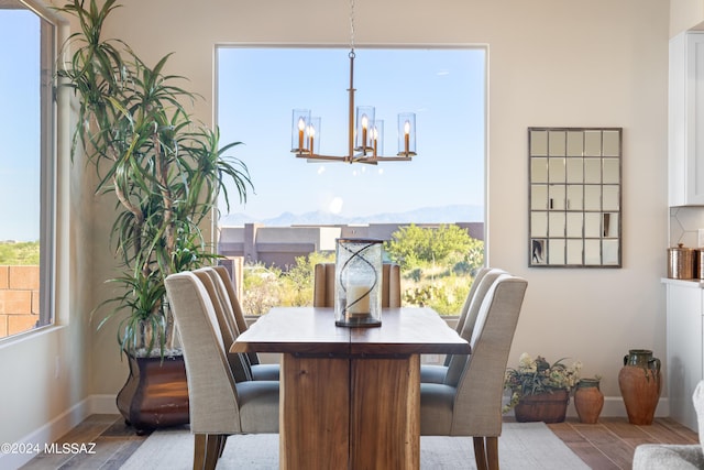 dining room featuring a notable chandelier and a mountain view