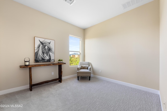 living area with light carpet