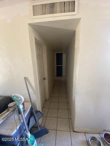 hall featuring light tile patterned flooring