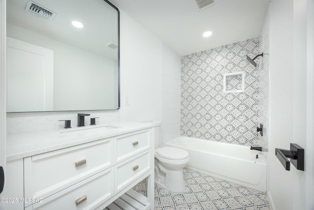 full bathroom with vanity, tiled shower / bath combo, and toilet