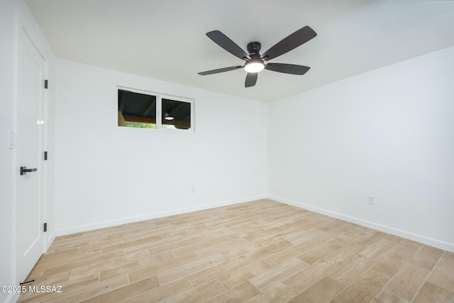 spare room with light hardwood / wood-style floors and ceiling fan