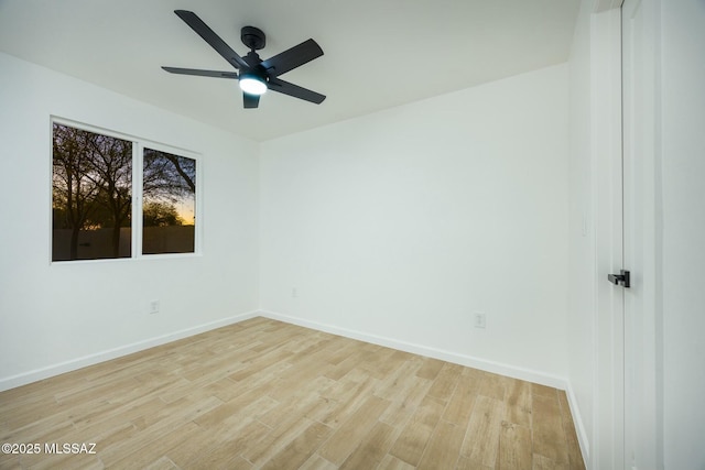 spare room with ceiling fan and light wood-type flooring