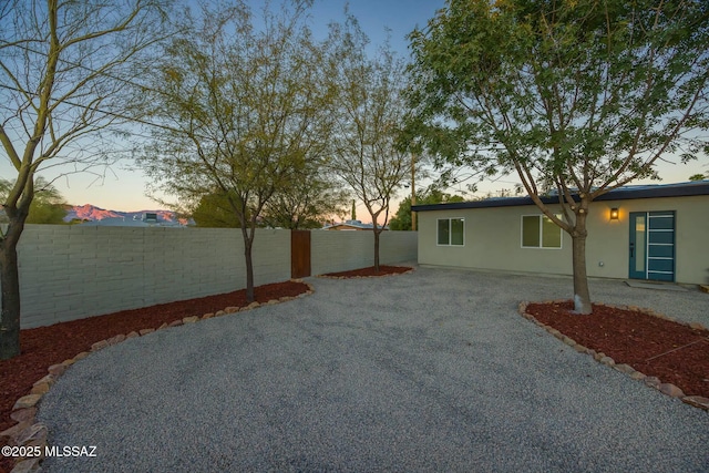 yard at dusk with a patio area