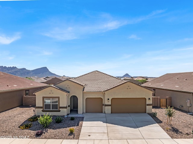 view of front facade featuring a mountain view and a garage