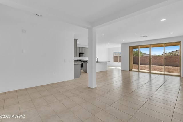 unfurnished living room featuring light tile patterned floors