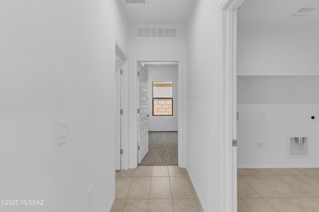 hallway featuring light tile patterned flooring