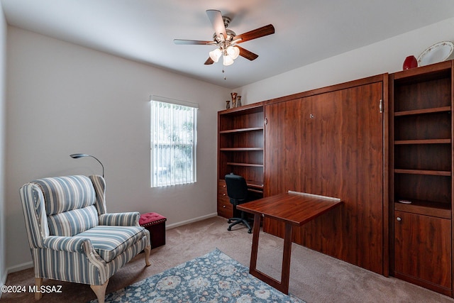 carpeted office space with ceiling fan