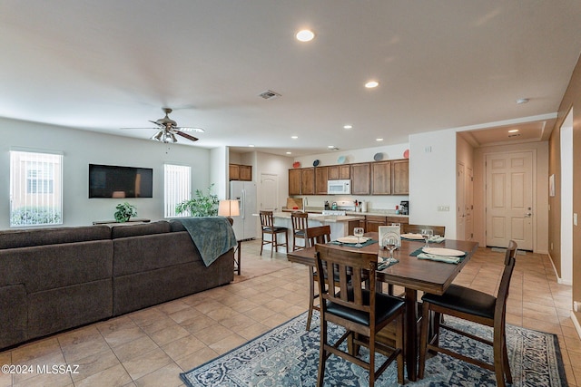 dining area featuring light tile patterned flooring, a wealth of natural light, and ceiling fan