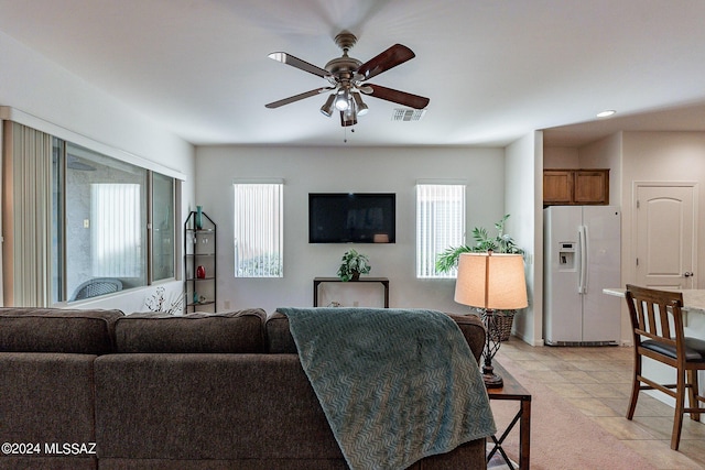 living room featuring light tile patterned floors and ceiling fan