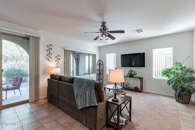 tiled living room with ceiling fan