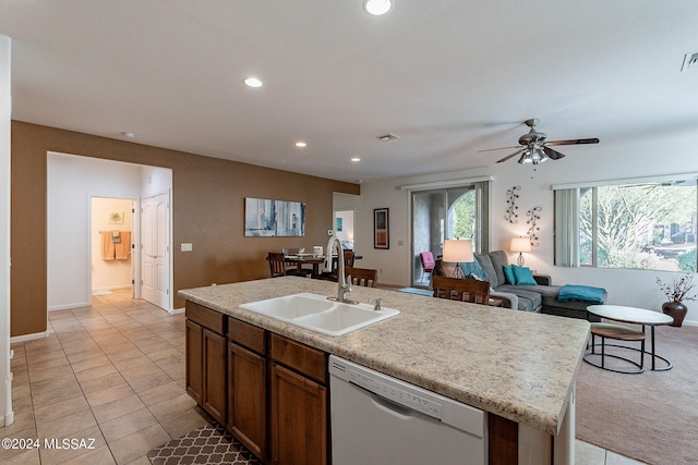 kitchen with sink, ceiling fan, dishwasher, a center island with sink, and light tile patterned flooring