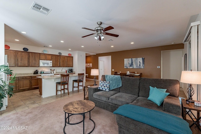 living room with light tile patterned floors and ceiling fan